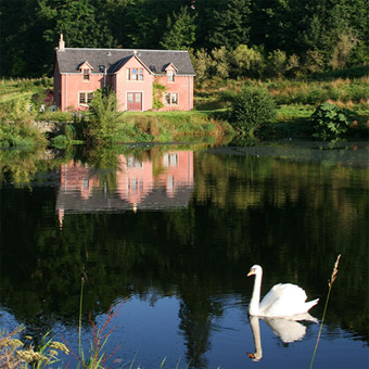 Sir Stuart's house, accommodation at Fingask Castle, with reflection on lake and swan in foreground